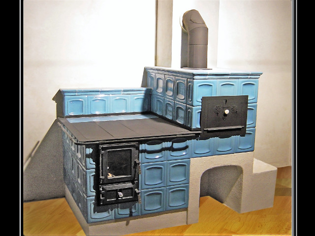 Kuchynský šporák s podmúrovkou, a zaústený do komína oceľovou rúrou. Výhody rúry sú zvýšený výkon kúrenia a účinnosť